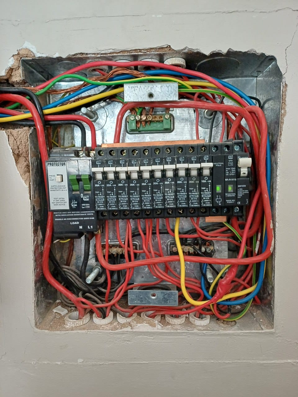 The main distribution board with the yellow geyser feed wire from the breaker and the blue neutral wire