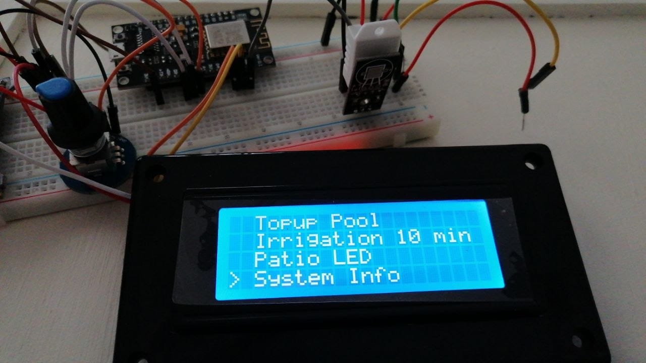 The same menu scrolled down to Topup Pool, Irrigation 10 min, Patio LED and System Info, with the breadboard, ESP32 and DHT22 visible behind the panel