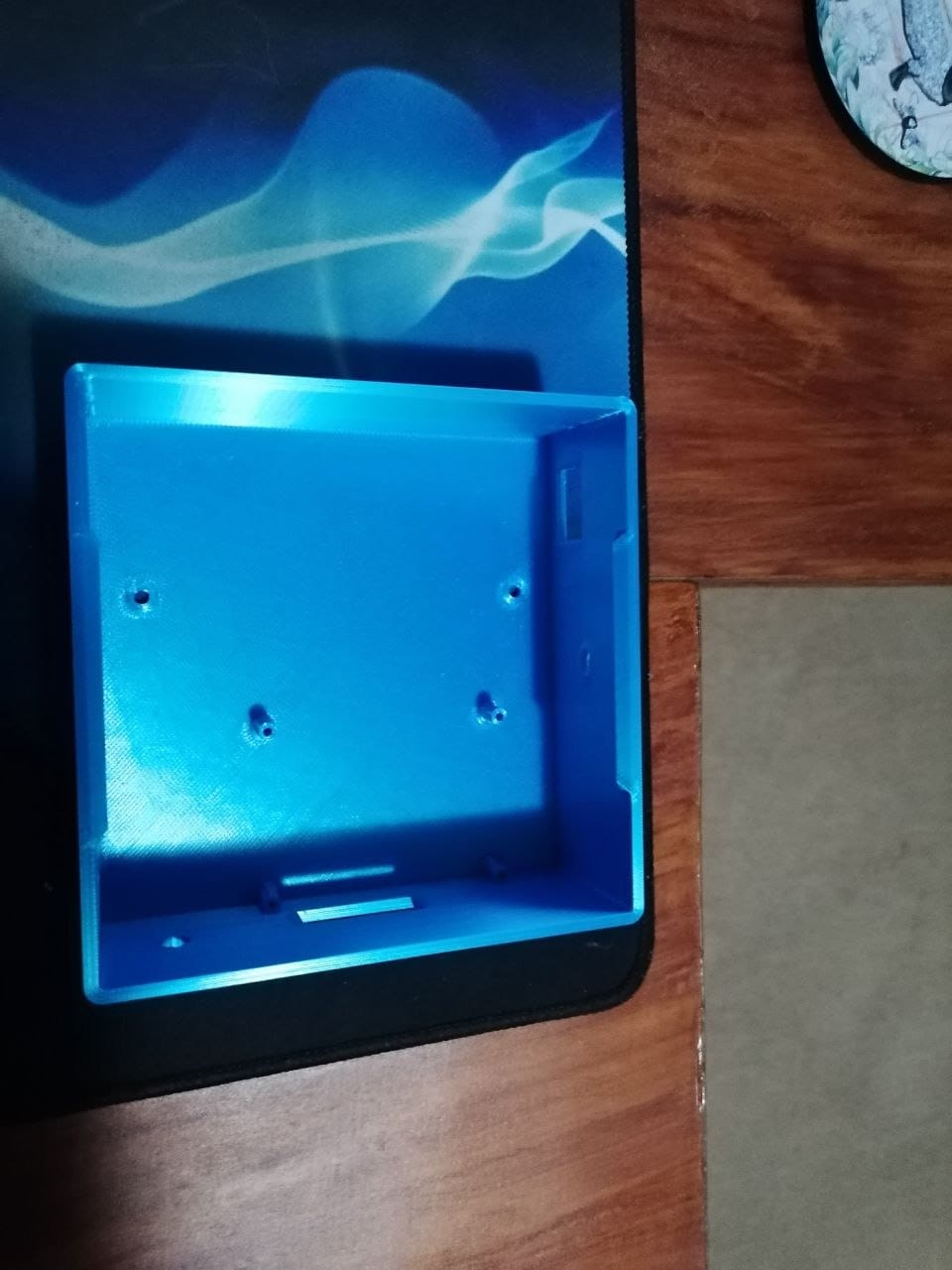 The inside of the raw 3D printed enclosure, showing the screw posts moulded into the print