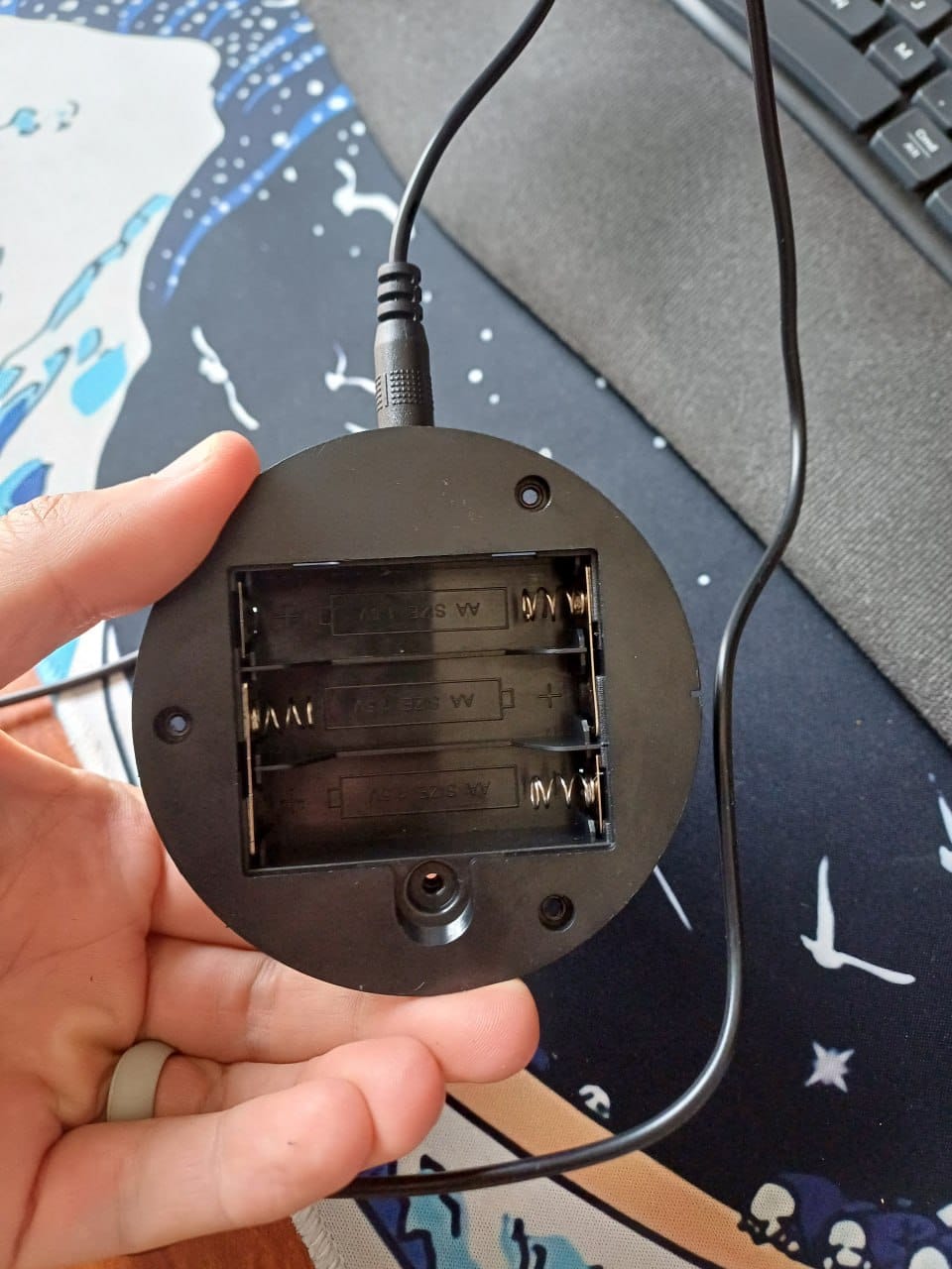 Underside of the lamp base showing the empty AA battery compartment