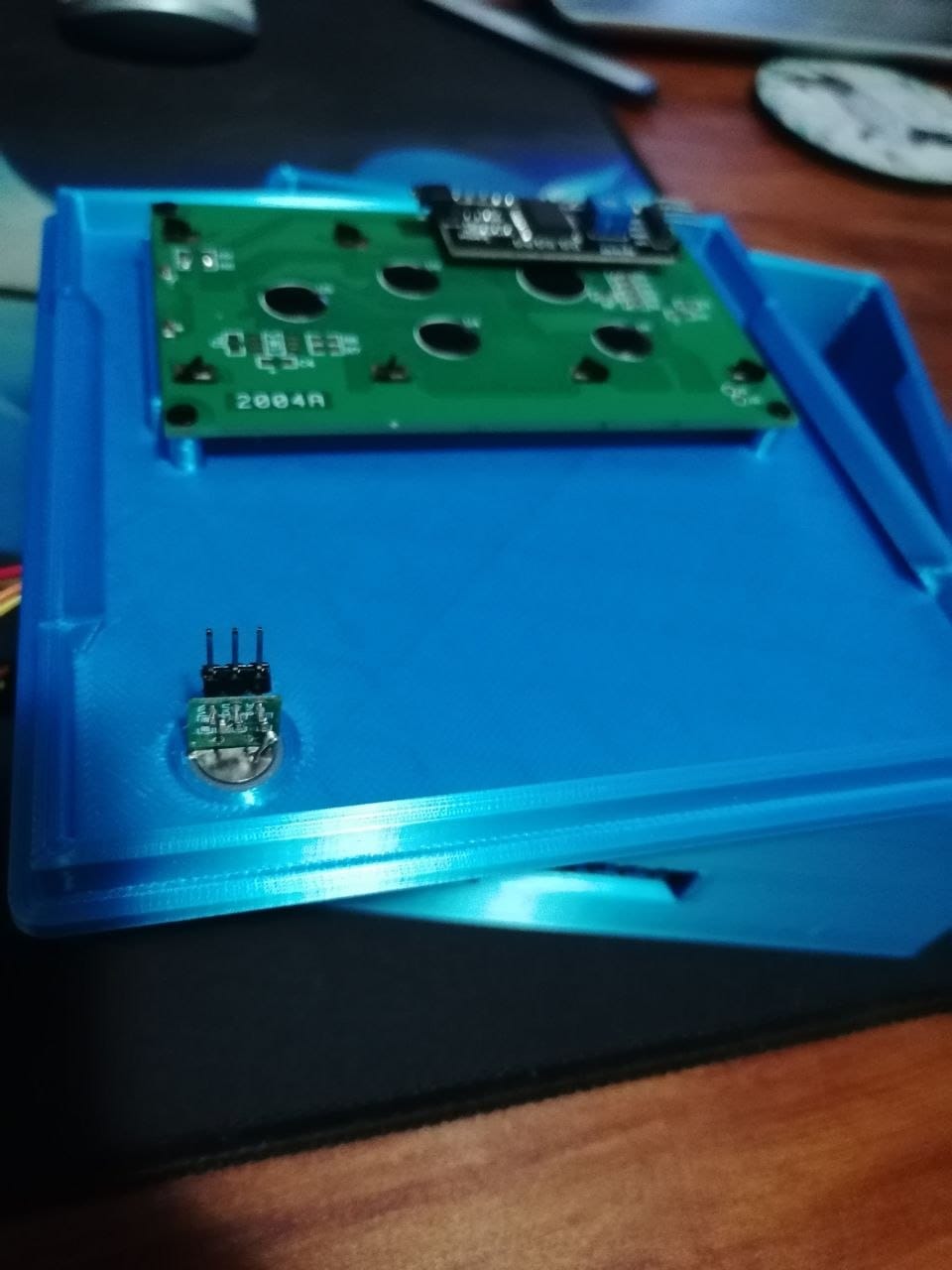 The 3D printed enclosure with the LCD board and the PIR sensor fitted into their mounting positions