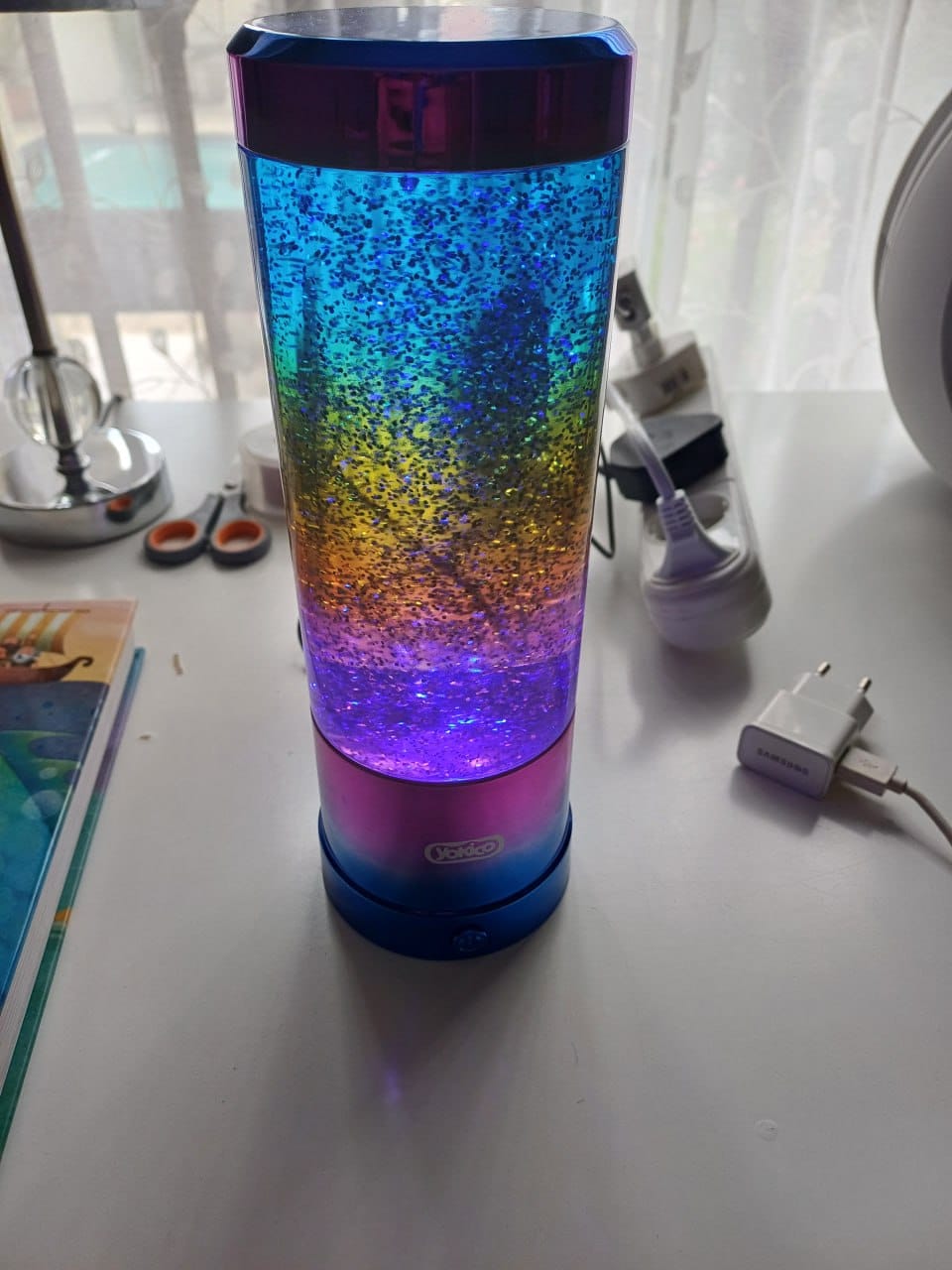 The finished lamp lit in Rainbow mode on a wooden desk