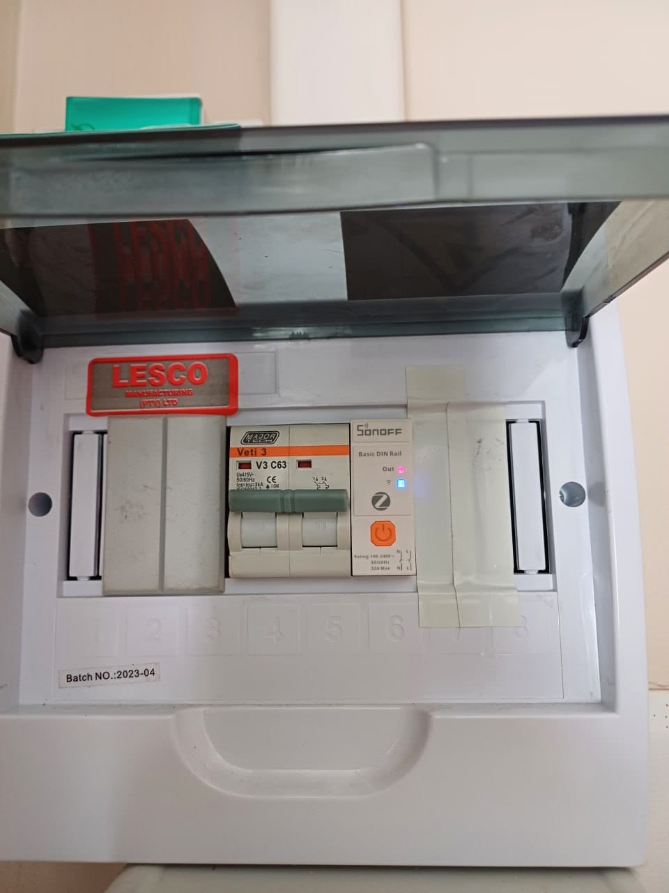The Sonoff Basic DIN Rail Zigbee switch installed in the same enclosure after the swap, with its Out indicator lit, next to the same Veti C63 breaker