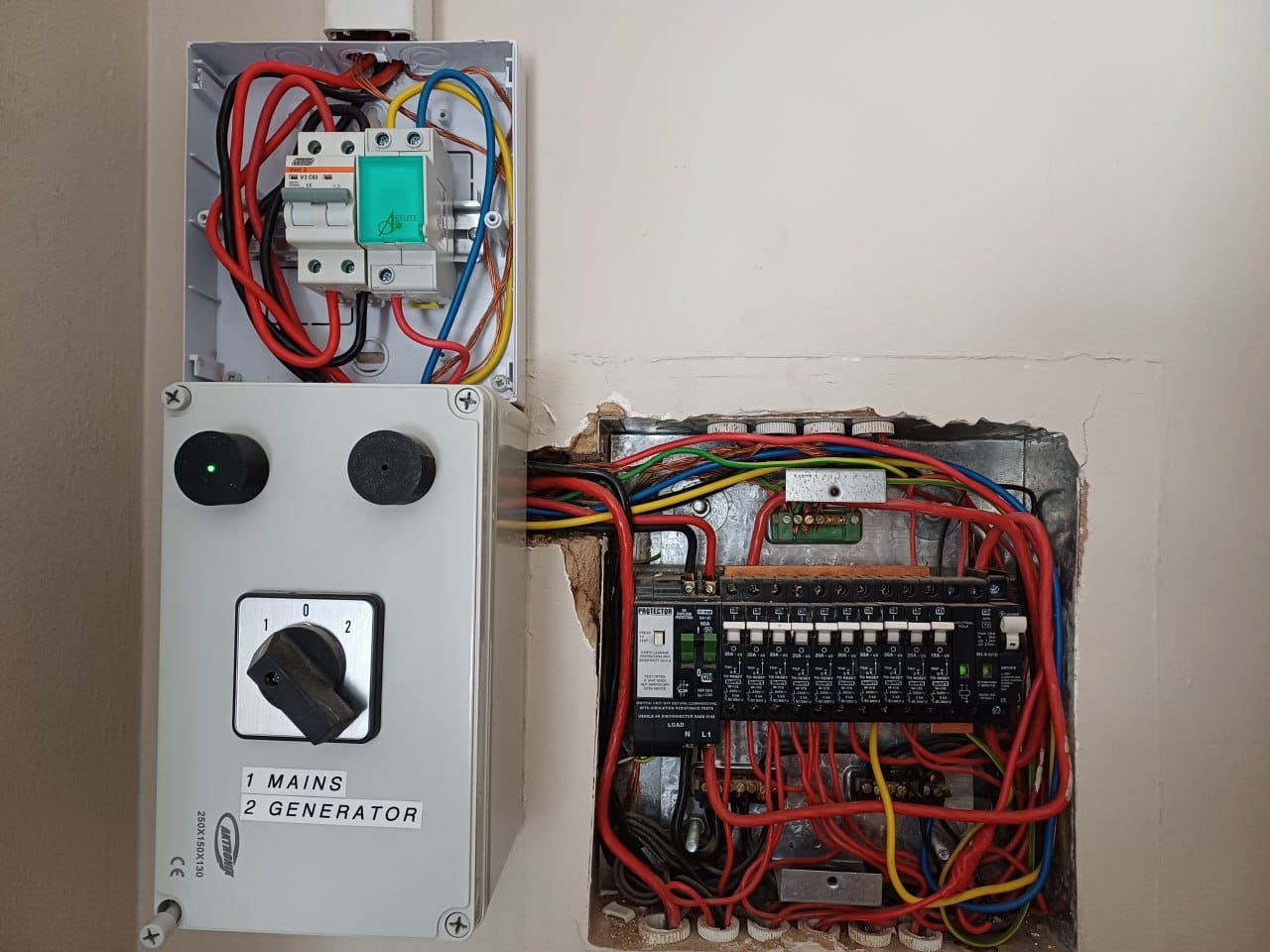 Wider view of the installation showing the mains and generator selector box, the geyser switch enclosure and the main distribution board